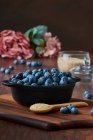 Detail of blueberries in a bowl on the wooden table — Stock Photo