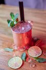 From above of copper mug with Moscow Mule cocktail made with vodka spicy ginger beer and lime juice topped with mint leaves — Stock Photo