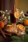 Gluhwein or christmas punch mulled wine server on a glass mug with dried orange slices — Stock Photo