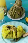 From above prepared of Juanes, typical amazonic food in plantains leaves. Typical jungle food with rice, chicken and dressings. — Stock Photo