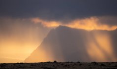 Mountain ridge located against cloudy sunrise sky in foggy morning in countryside of Iceland — Stock Photo