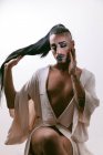 Ritratto di donna barbuta transgender glamour in sofisticato make con gli occhi chiusi sullo sfondo neutro — Foto stock