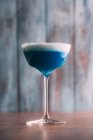 Blue cocktail on a wooden table — Stock Photo
