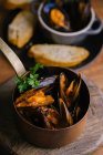 Delectable mussels with herbs in metal saucepan — Stock Photo