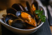 Delectable mussels with herbs in bowl — Stock Photo