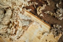 Top view of pile of sheared wool of sheep scattered on wooden floor in barn in countryside — Stock Photo