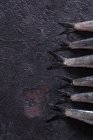 Récolte vue de près des queues d'anchois crues couchées sur une surface sombre — Photo de stock