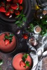 Top view of bowl with fresh strawberry gazpacho cold soup placed on dark table — Stock Photo