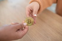 Unrecognizable black girl holding cryptocurrency with hands — Stock Photo