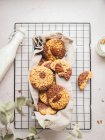 From above of yummy cookies with walnuts and glass bottle of milk placed on baking net on table — Stock Photo