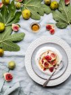 Top view plate of yogurt with figs on a table — Stock Photo
