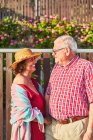 Счастливая пожилая пара наслаждается прогулкой вместе стоя глядя друг на друга — стоковое фото