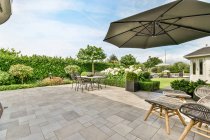 Patio with meadow against residential buildings and couch under roof in Province of Utrecht Netherlands — Stock Photo