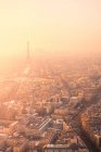 Air view of city district with residential buildings and Eiffel Tower on Champ de Mars in haze in Paris — стоковое фото