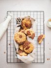 From above of yummy cookies with walnuts and glass bottle of milk placed on baking net on table — Stock Photo