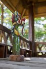 Sculpture of dragon with ornament on pedestal in aged construction made of bamboo in Bali Indonesia — Stock Photo