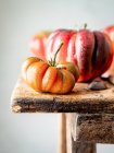 Closeup of several red tomatoes on a wooden table — Stock Photo