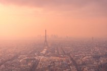 Aerial view of city district with residential buildings and Eiffel Tower on Champ de Mars in haze in Paris — Stock Photo