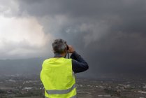Back view of anonymous man observing the erupting volcano of Cumbre Vieja in La Palma Canary Islands 2021 — Stock Photo
