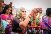 INDIEN, VARANASI - 27. NOVEMBER 2015: Ethnische Frauen in traditioneller Kleidung und traditionelle indische Verkäuferinnen in traditioneller Kleidung und traditionellen indischen Hüten mit konischem Ritual — Stockfoto