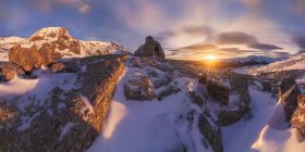 Spectacular scenery of small stone house located on top of snowy mountain in highland area in winter time at sunrise — Stock Photo
