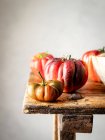 Closeup of several red tomatoes on a wooden table — Stock Photo