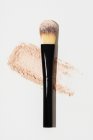 Compact cosmetic face and makeup brush placed on white background — Stock Photo