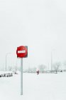Red traffic sign prohibiting entry on post in snow near road in winter day in Madrid — Stock Photo