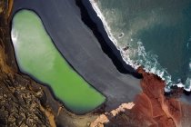 Luftaufnahme von Charco Verde gegen schäumenden Ozean auf dem Hochland in Golfo Yaiza Lanzarote Kanarische Inseln Spanien — Stockfoto