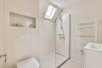 Conception créative de salle de bains avec lavabo et cuvette de toilette contre salle de douche avec mur de verre à la maison — Photo de stock