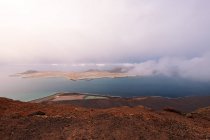 Picturesque view of Graciosa Island with canic mounts among Strait of Rio at sundown in Teguise Lanzarote Spain — стокове фото
