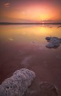 Lake with clear pink water and salt located in famous national park in Torrevieja city of Spain in evening time during sunset — Stock Photo