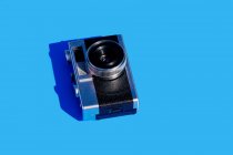 From above vintage photo camera on bright blue background — Stock Photo