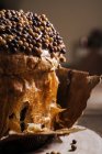 Sweet homemade baked panettone on round wooden stand for celebrating Christmas — Stock Photo