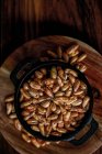 Top view of pile of cereal grain in bowl placed on wooden table in kitchen — Stock Photo