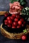 Bowl with fresh sweet plums served on black table — Stock Photo