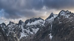 Landscape of snowy mountains covered by clouds. National Park Picos de Europa, Spain — Stock Photo