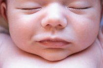 Vista superior de bonito pequeno bebê recém-nascido nu adorável dormindo deitado em cama macia em casa — Fotografia de Stock