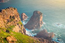 From above view of sea water splashing near rocks of Cape Roca located in Sintra Cascais Natural Park at sunrise in Portugal — Stock Photo