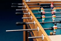 High angle of detail of retro table soccer with wooden miniature figurines of players on metal bars — Stock Photo