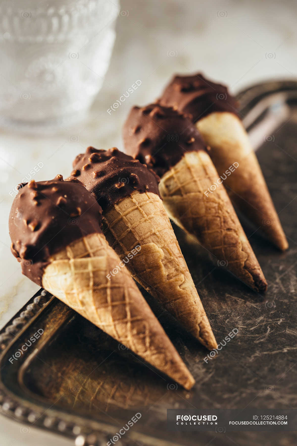 Chocolate ice cream cones — nuts, vertical image Stock Photo 125214884