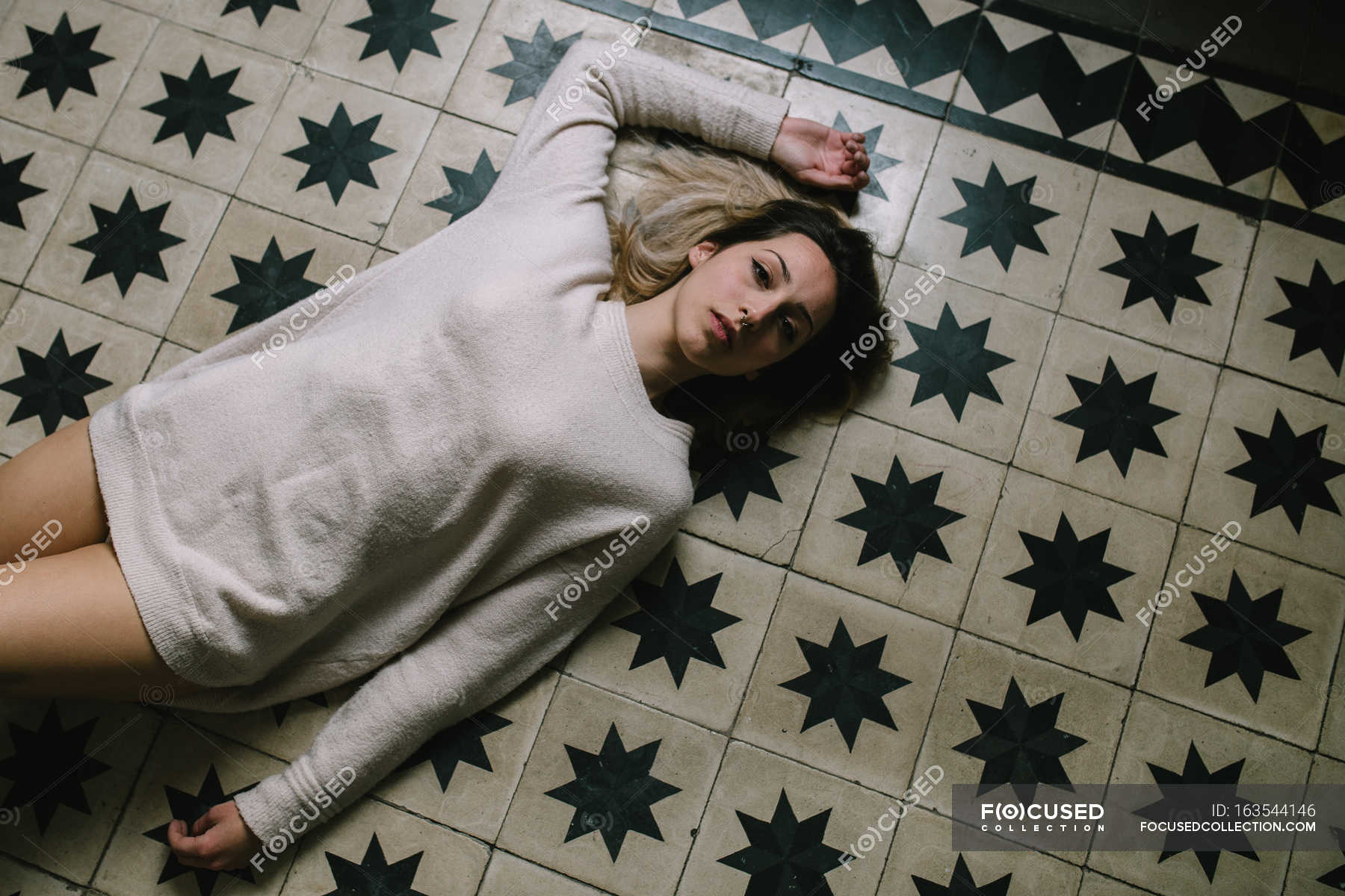 Woman Lying On Floor Elegance Posing Stock Photo