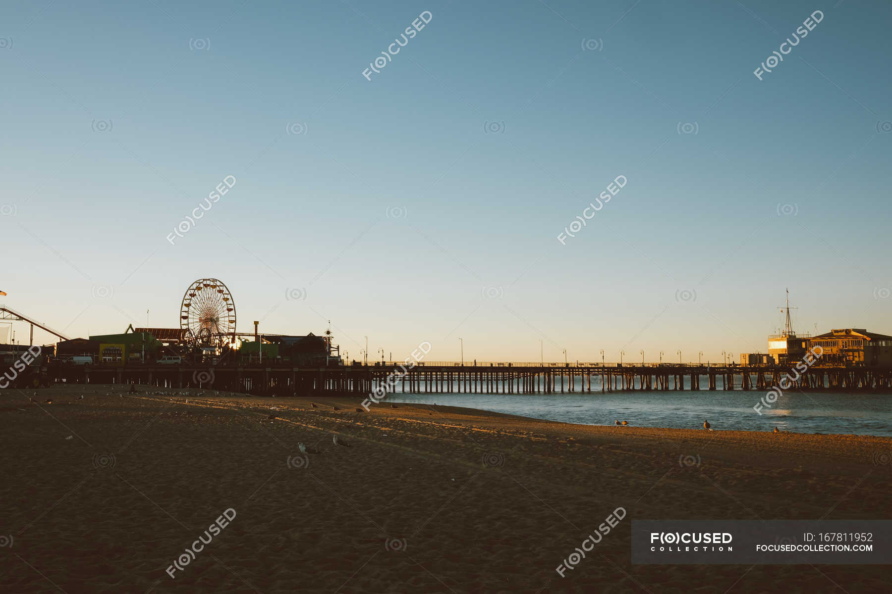 Amusement park on pier — dusk, evening - Stock Photo | #167811952