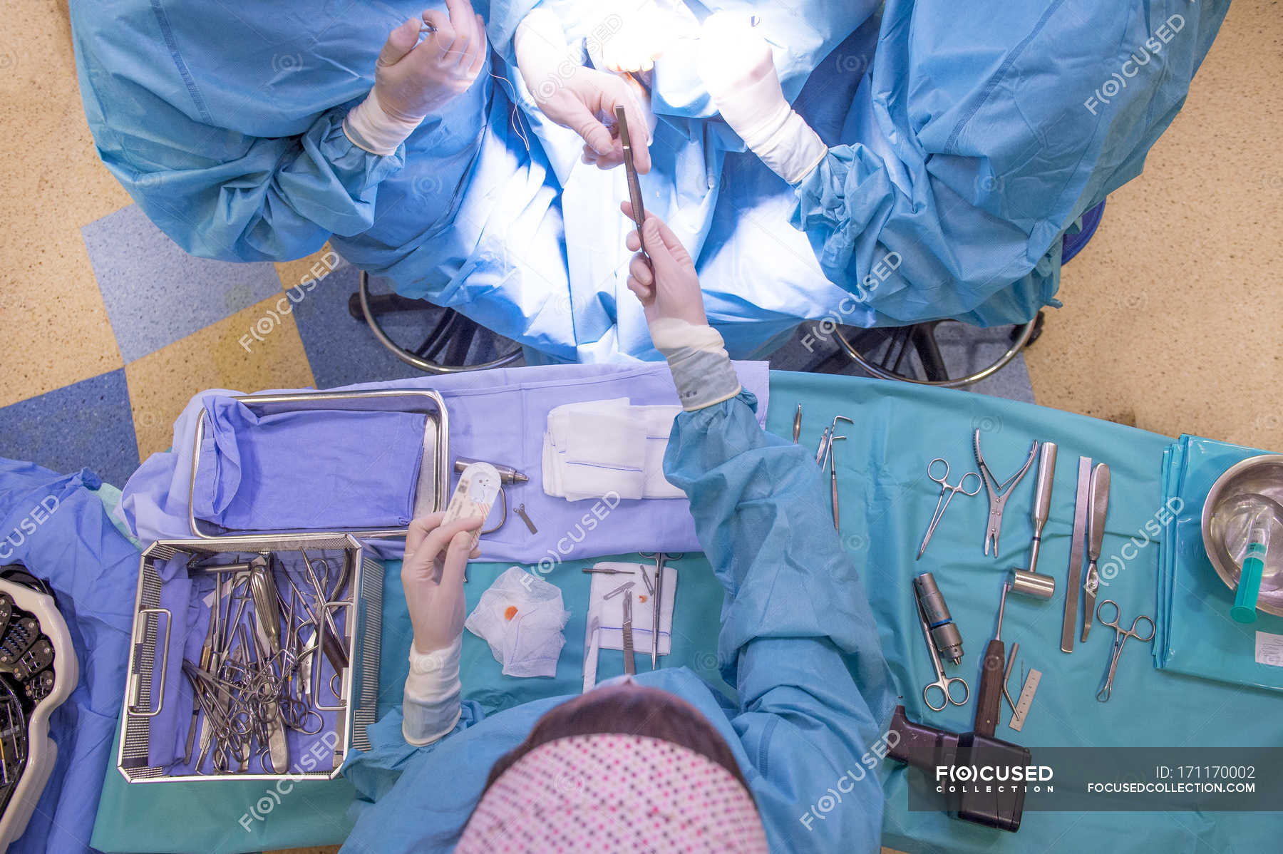 top-view-of-medical-workers-standing-over-table-with-equipment-for