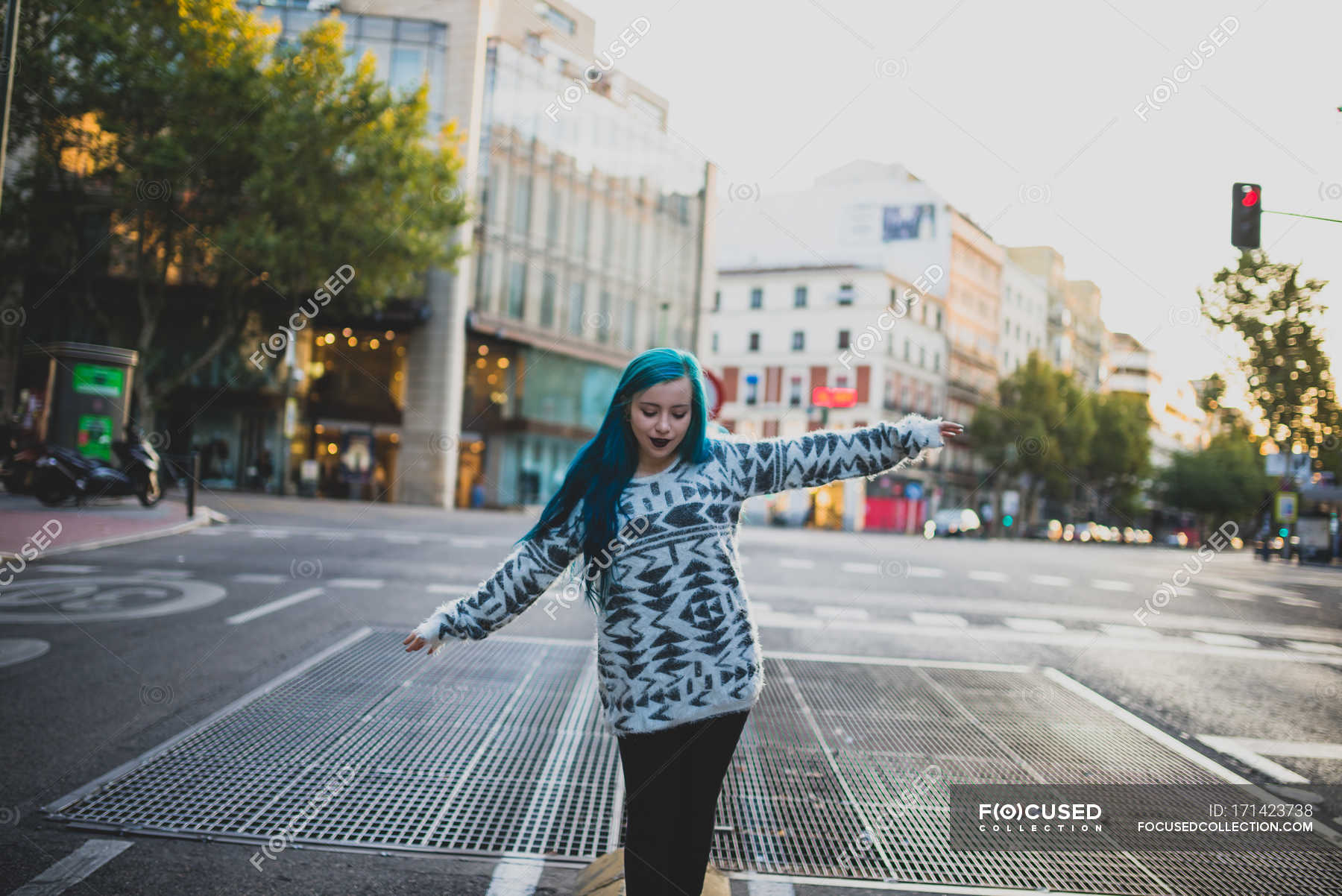 Portrait Of Blue Haired Girl Walking With Half Raised Arms And Looking Down At Urban Scene Outdoors Female Stock Photo