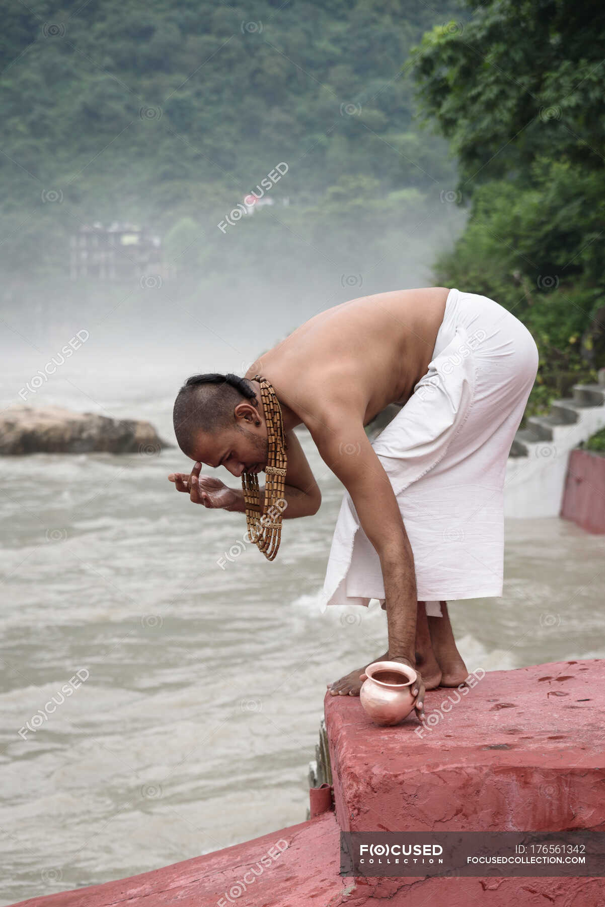 side-view-of-man-putting-dot-on-forehead-at-river-city-exotic