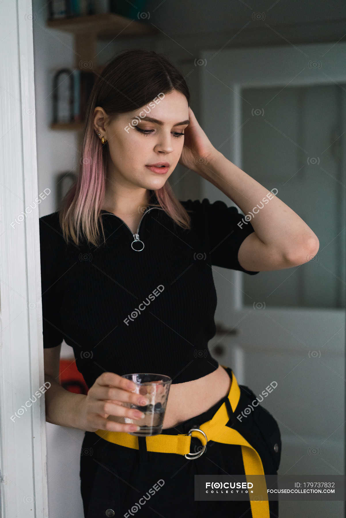 Portrait Of Woman Posing At Doorway With Glass Of Water In Hands — Happiness Copy Space Stock 4931
