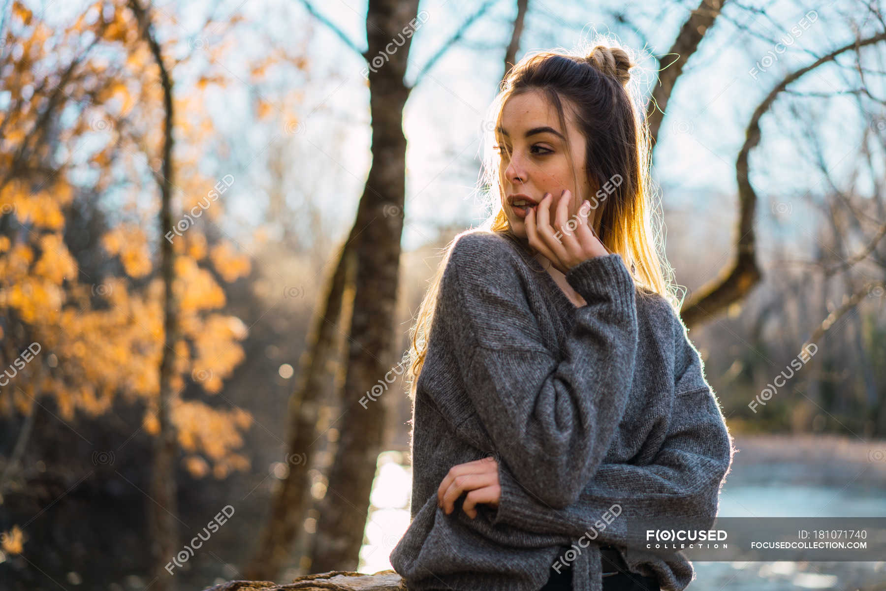 Side view of dreamy woman posing in autumnal woods — horizontal, forest