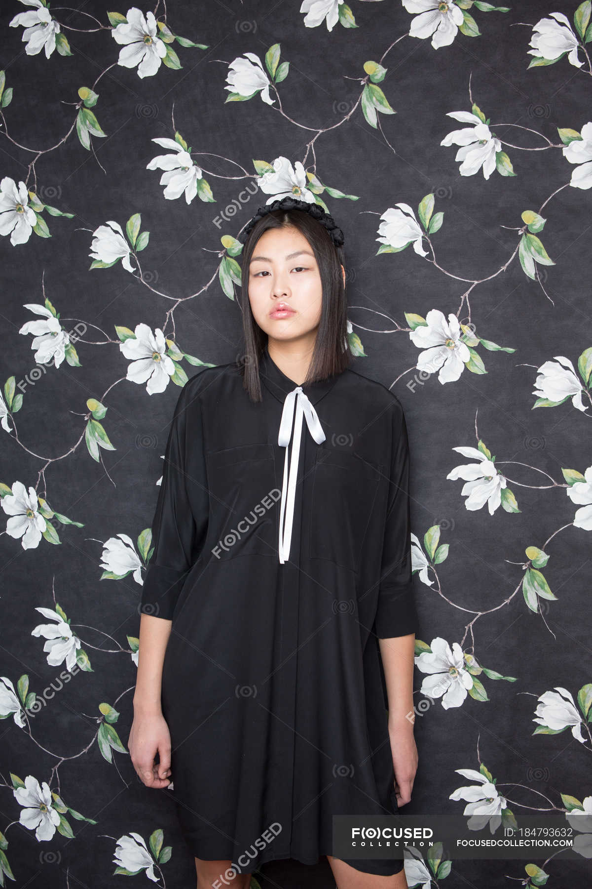 Pretty Young Woman In Black Dress Looking At Camera And Posing On On Pretty Young Woman In Black Dress Looking At Camera And Posing On On