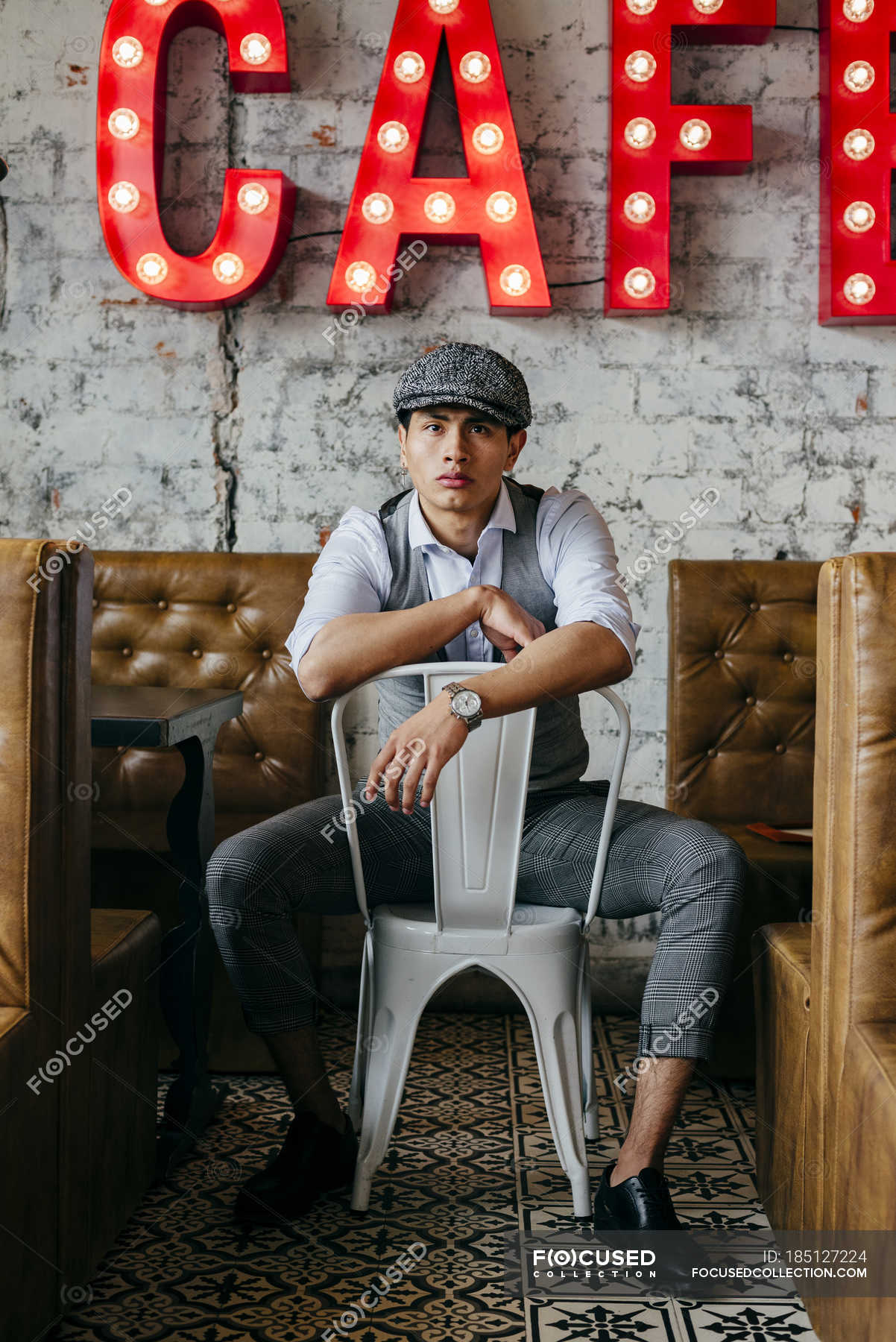 Man in vintage clothes posing on chair in cafe — style, youth - Stock Photo  | #185127224